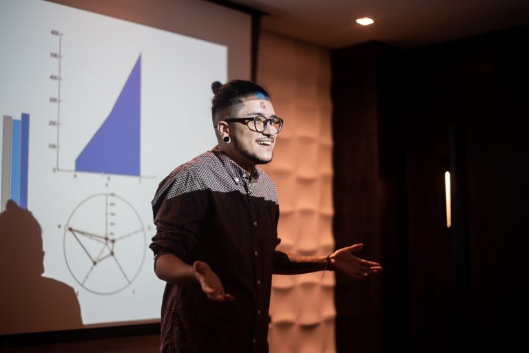 Confident and happy man lecturing at a conference.